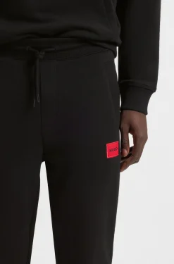Jogginghose aus Baumwoll-Terry mit rotem Logo-Label