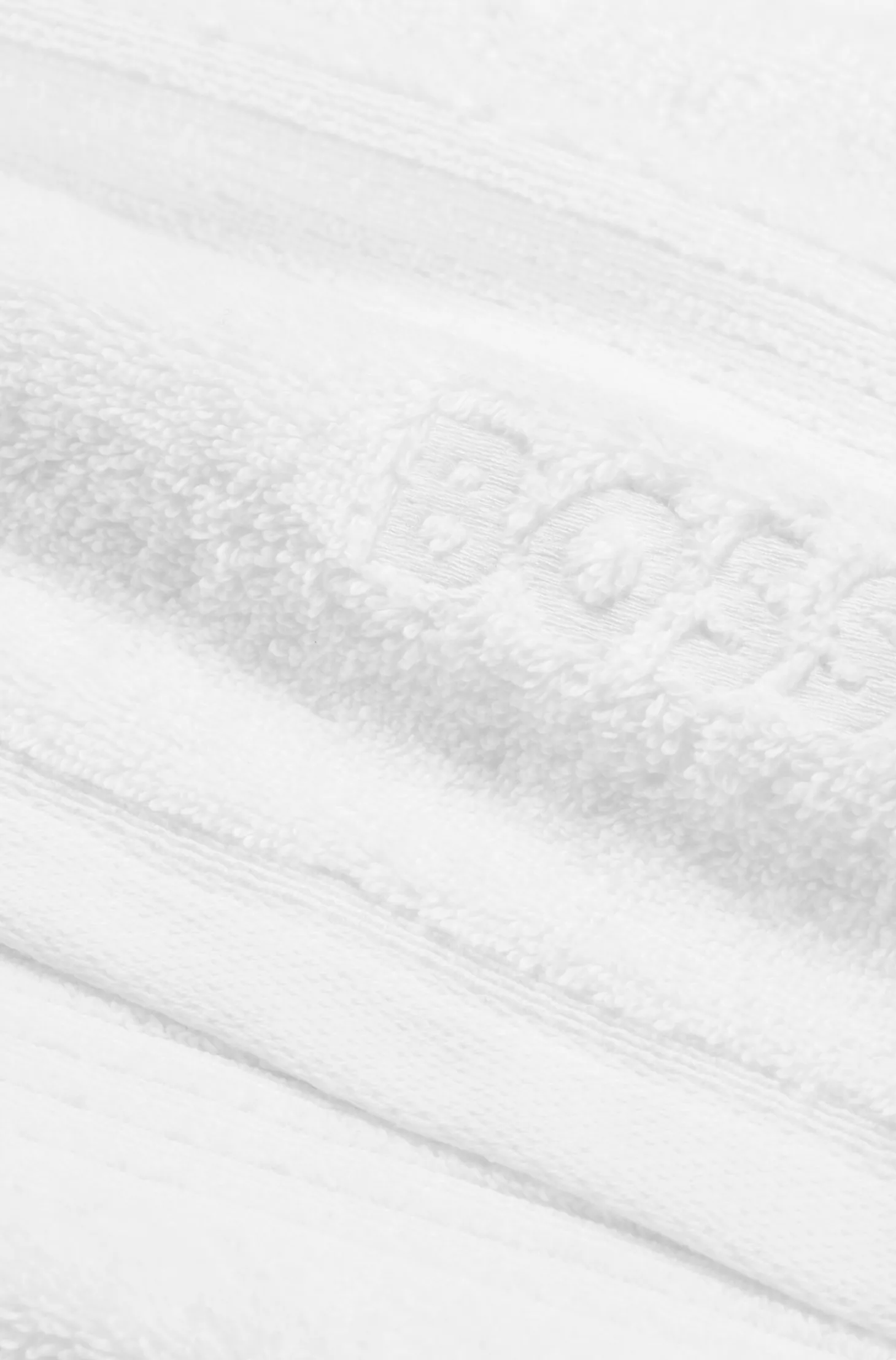 Weiße Badematte aus Baumwolle mit gesticktem Logo